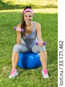 Fitness Healthy Smiling Young Woman Resting on Pilates Ball. Стоковое фото, фотограф Mitar gavric / PantherMedia / Фотобанк Лори