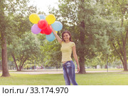 Happy Young Woman With Colorful Balloons. Стоковое фото, фотограф Mitar gavric / PantherMedia / Фотобанк Лори
