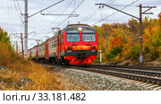 Russia, Samara, September 2019: Passenger train with wagons Ed4m moves by rail through the beautiful Autumn Forest. Редакционное фото, фотограф Акиньшин Владимир / Фотобанк Лори