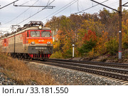 Russia, Samara, September 2019: Passenger train with wagons VL10 moves by rail through the beautiful Autumn Forest. Редакционное фото, фотограф Акиньшин Владимир / Фотобанк Лори