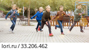 Smiling children playing romp game Touch-last. Стоковое фото, фотограф Яков Филимонов / Фотобанк Лори