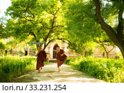 Young Buddhist novice monks running outside monastery. Стоковое фото, фотограф Wong Sze Fei / PantherMedia / Фотобанк Лори
