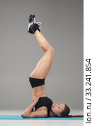 Beautiful sporty girl standing in acrobat pose or yoga asana. Стоковое фото, фотограф Volodymyr Melnyk / PantherMedia / Фотобанк Лори