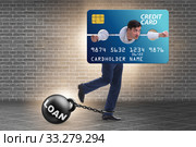 Businessman in credit card burden concept in pillory. Стоковое фото, фотограф Elnur / Фотобанк Лори