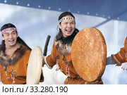 Two aborigine dancers in national clothes of indigenous people dancing with tambourine. Concert Koryak Dance Ensemble Mengo (2019 год). Редакционное фото, фотограф А. А. Пирагис / Фотобанк Лори