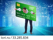 Businessman in credit card burden concept in pillory. Стоковое фото, фотограф Elnur / Фотобанк Лори