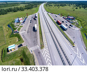 Wide straight toll highway M-11 is passing in forest. View from above. The Moscow-Saint Petersburg motorway is designed as the M11 Neva (2018 год). Редакционное фото, фотограф Кекяляйнен Андрей / Фотобанк Лори