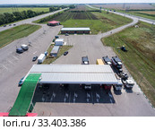 Aerial view at petrol station with trucks, passenger cars filling gas, it is located between two highways, plain terrain. Стоковое фото, фотограф Кекяляйнен Андрей / Фотобанк Лори