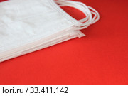 Antiviral masks on red background with copy space. Protective masks. Стоковое фото, фотограф Попова Ольга / Фотобанк Лори