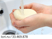 Children's hands holding soap under running water under bathroom sink faucet. Стоковое фото, фотограф Попова Ольга / Фотобанк Лори