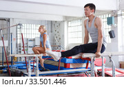 Couple doing exercises on parallel bars. Стоковое фото, фотограф Яков Филимонов / Фотобанк Лори