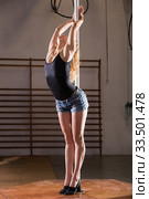 Sexy girl in denim shorts performs a dance with a pylon. Стоковое фото, фотограф Яков Филимонов / Фотобанк Лори
