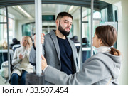 Portrait of playful positive people making acquaintance in public transport. Стоковое фото, фотограф Яков Филимонов / Фотобанк Лори
