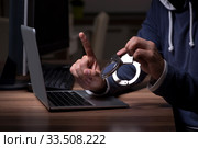 Male hacker hacking security firewall late in office. Стоковое фото, фотограф Elnur / Фотобанк Лори