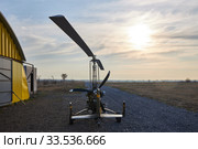 Single place ultralight homemade gyroplane stands at the airport near the hangar in the early morning. Стоковое фото, фотограф Олег Белов / Фотобанк Лори