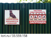 Таблички с угрожающими и запрещающими надписями на частном металлическом заборе (2018 год). Редакционное фото, фотограф Светлана Попова / Фотобанк Лори