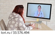 A woman with a respiratory disease is on sick leave and is looking at a computer video consultation doctor. The therapist provides live coverage for patients. A nurse gives advice online. Стоковое видео, видеограф Михаил Решетников / Фотобанк Лори