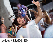 positive male joying and thumbs up on party in the club with coc. Стоковое фото, фотограф Яков Филимонов / Фотобанк Лори