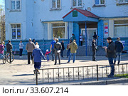 Люди соблюдают социальную дистанцию перед входом в почтовое отделение. Эпидемия коронавируса COVID-19 в России. Калининград, улица Комонавтв Леонова, 22 (2020 год). Редакционное фото, фотограф Ирина Борсученко / Фотобанк Лори