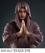 Monk in religious concept on gray background. Стоковое фото, фотограф Elnur / Фотобанк Лори
