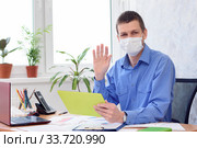 Портрет офисного работника в медицинской маске, работающего удаленно. Стоковое фото, фотограф Иванов Алексей / Фотобанк Лори