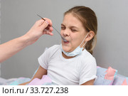 Девочка пьет с ложечки очень противное лекарство. Стоковое фото, фотограф Иванов Алексей / Фотобанк Лори