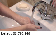 Washing hands under water stream in domestic faucet, turn off the tap, close up view at Caucasian arms. Стоковое видео, видеограф Кекяляйнен Андрей / Фотобанк Лори