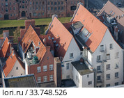 Lubeck, Germany. Red tiled roofs of old houses in the Old Town (2018 год). Стоковое фото, фотограф Наталья Николаева / Фотобанк Лори