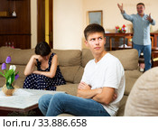 Spouses quarrelling while their son sitting. Стоковое фото, фотограф Яков Филимонов / Фотобанк Лори