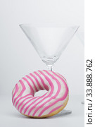 Martini glass and pink donut. Close-up. Стоковое фото, фотограф Evgeny Miller / Фотобанк Лори