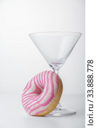 Martini glass and pink donut. Close-up. Стоковое фото, фотограф Evgeny Miller / Фотобанк Лори