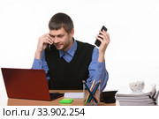 dispatcher solves problems by talking on two phones. Стоковое фото, фотограф Иванов Алексей / Фотобанк Лори