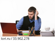 A tired employee negotiates on the phone looking into the screen of the laptop. Стоковое фото, фотограф Иванов Алексей / Фотобанк Лори