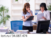 Two female employees and excessive work in the office. Стоковое фото, фотограф Elnur / Фотобанк Лори