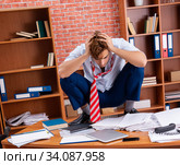 Unhappy businessman sitting in the office. Стоковое фото, фотограф Elnur / Фотобанк Лори