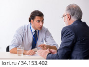 Old businessman meeting with advocate in pre-trial detention. Стоковое фото, фотограф Elnur / Фотобанк Лори