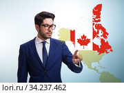 Concept of immigration to Canada with virtual button pressing. Стоковое фото, фотограф Elnur / Фотобанк Лори