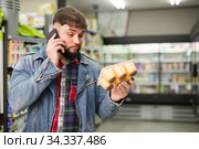 man talking on phone about purchasing of yogurts. Стоковое фото, фотограф Яков Филимонов / Фотобанк Лори