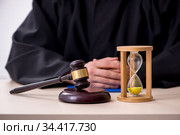 Young male judge in time management concept. Стоковое фото, фотограф Elnur / Фотобанк Лори