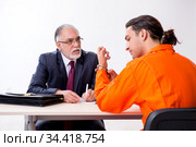 Young captive meeting with advocate in pre-trial detention. Стоковое фото, фотограф Elnur / Фотобанк Лори