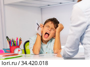 Painful expression of autistic boy learn numbers. Стоковое фото, фотограф Сергей Новиков / Фотобанк Лори