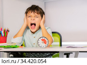 Sad angry boy during ABA therapy for autists. Стоковое фото, фотограф Сергей Новиков / Фотобанк Лори