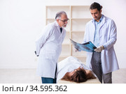 Police coroner examining dead body corpse in morgue. Стоковое фото, фотограф Elnur / Фотобанк Лори
