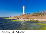 Rocky coast with white lighthouse at sea. Стоковое фото, фотограф Дмитрий Тищенко / Фотобанк Лори