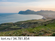 View of the sea bay with the city of Koktebel in the Crimea at sunset, against the background of mountains (2019 год). Стоковое фото, фотограф Сергей Фролов / Фотобанк Лори