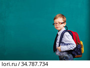 Cheerful smiling little kid with big backpack. Стоковое фото, фотограф Nataliia Zhekova / Фотобанк Лори