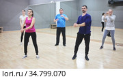 Cheerful people practicing vigorous lindy hop movements in dance class. Стоковое видео, видеограф Яков Филимонов / Фотобанк Лори