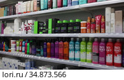 Various of haircare cosmetics and wigs for sale on shelves of specialty cosmetic shop (2020 год). Редакционное видео, видеограф Яков Филимонов / Фотобанк Лори