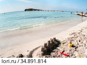 White sand and turquoise sea water are on the Nissi beach. It is a popular beach in the resort of Ayia Napa, Cyprus, Europe. The beach have small islet of Nissi. Wide angle view (2010 год). Стоковое фото, фотограф Кекяляйнен Андрей / Фотобанк Лори