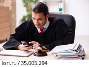 Young male lawyer working in the courthouse. Стоковое фото, фотограф Elnur / Фотобанк Лори